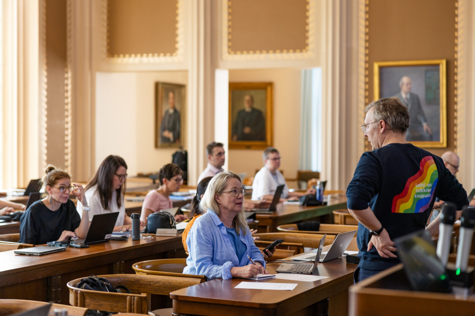 Harjoitukseen osallistujia istumassa pöydän ääressä.